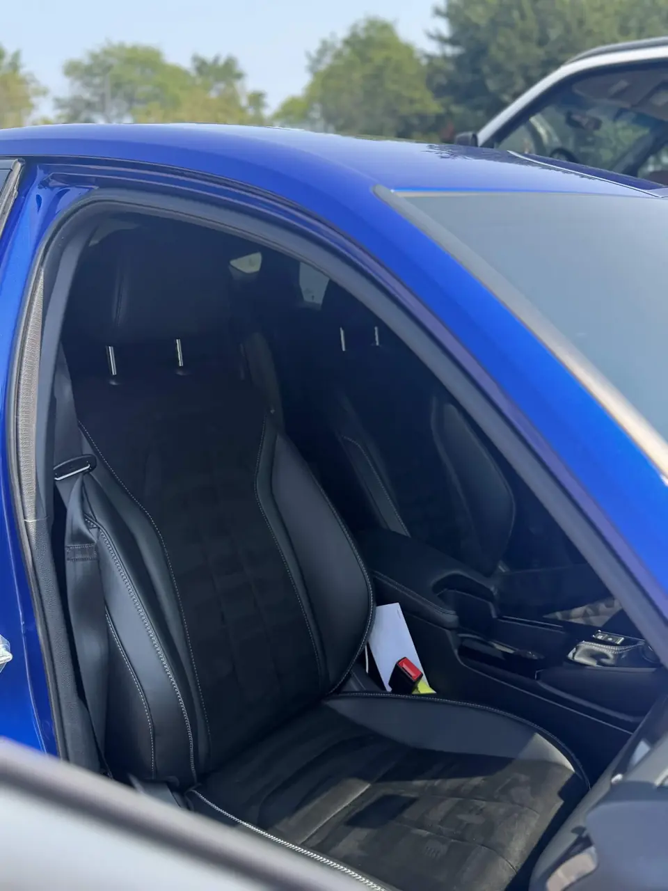 Blue BMW 3 Series with black Alcantara seats after a detail