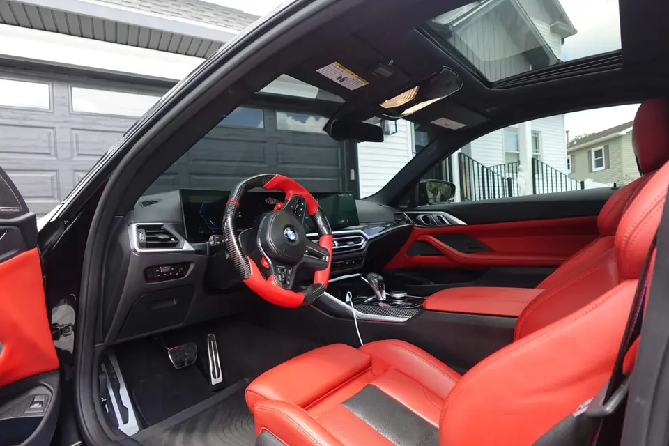 BMW M4 Competition red leather interior after a weekly detail