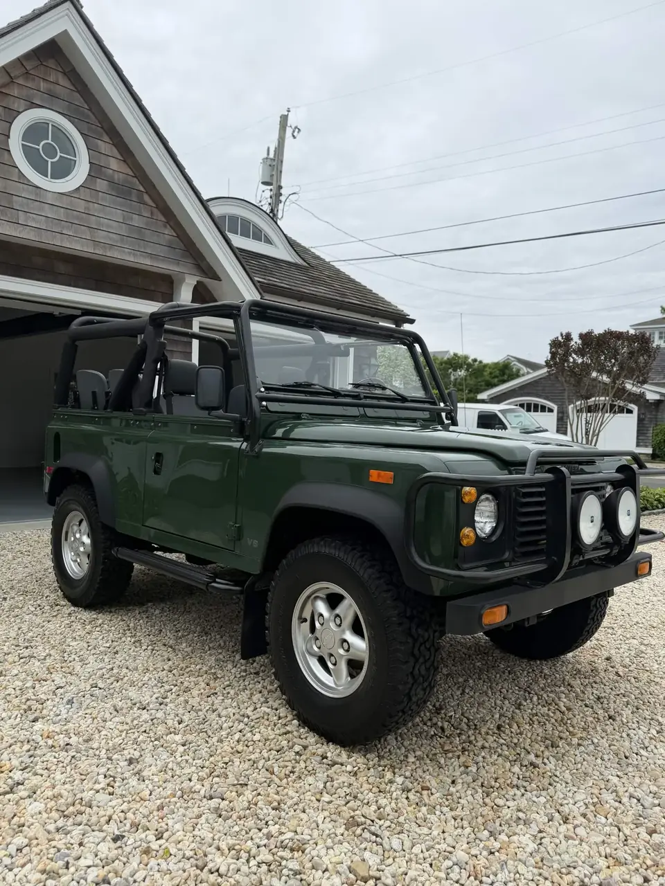 Green Land Rover Defender 90 V8 convertible after a weekly detail