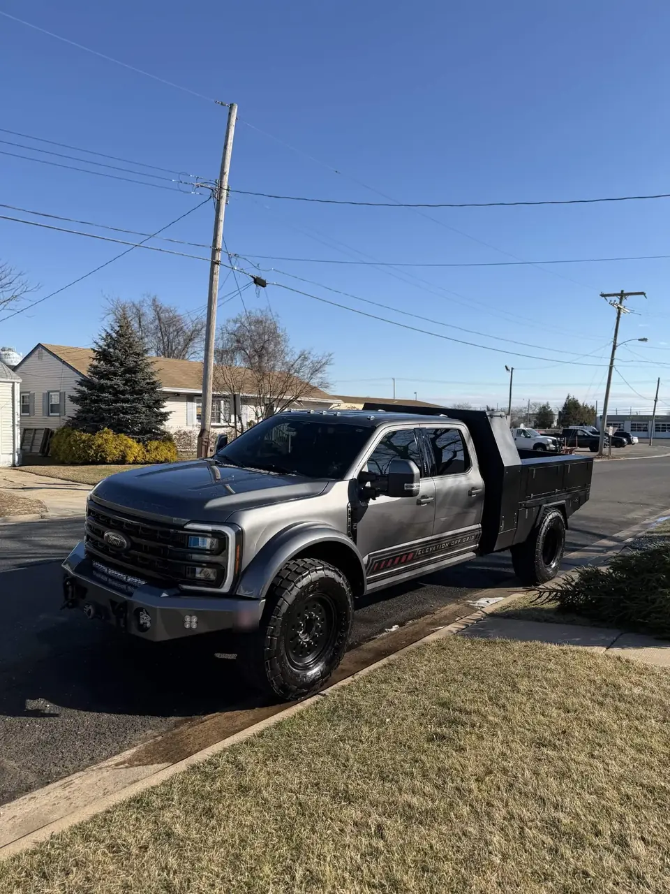 Grey Ford Super Duty flatbed work truck after a monthly detail