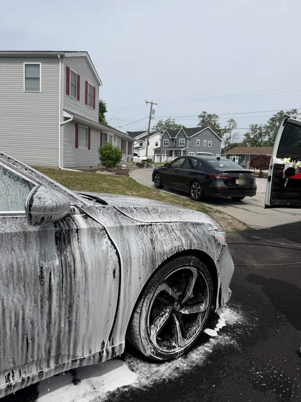 Honda Accord covered in snow foam during a maintenance wash