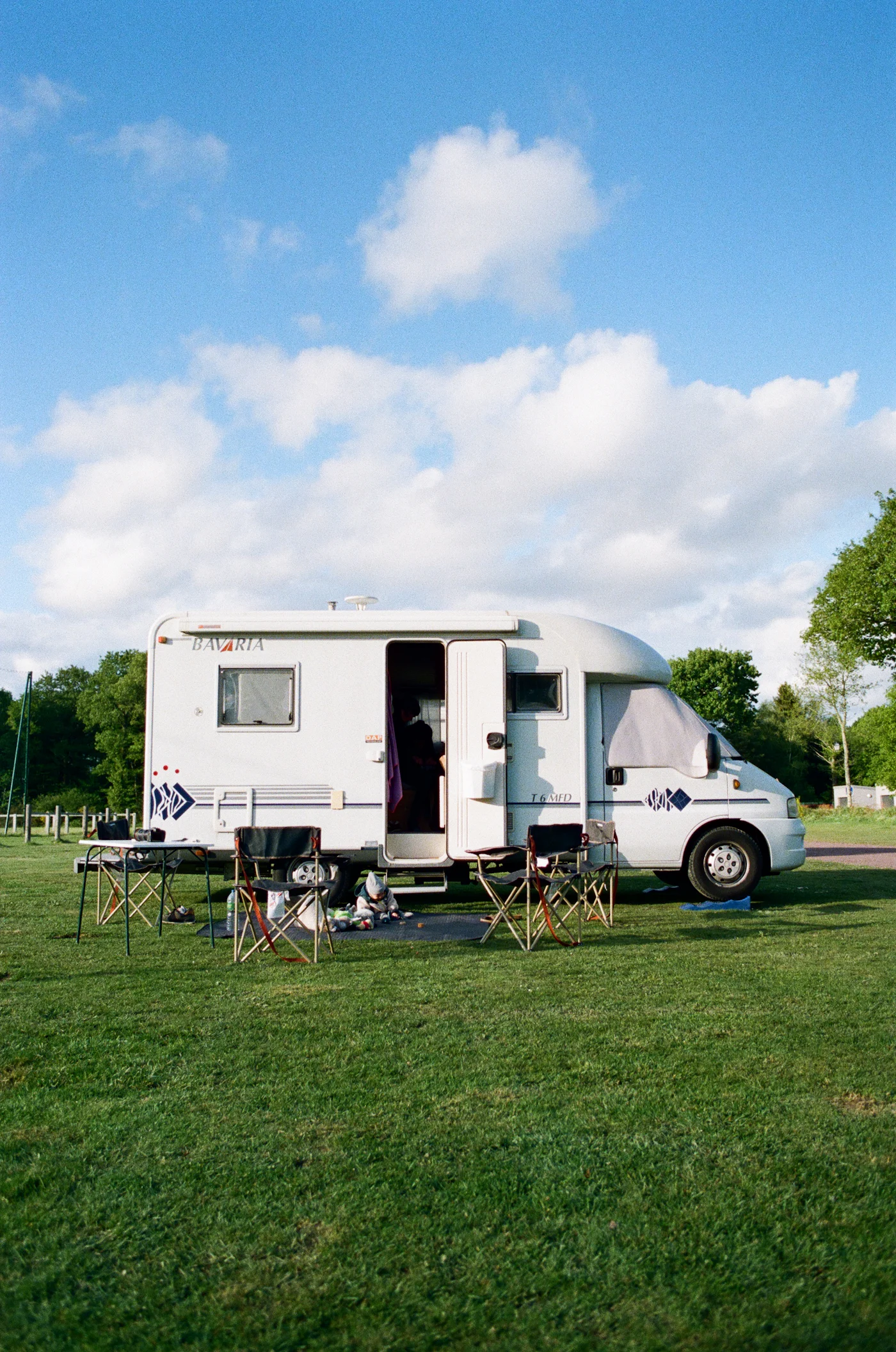 RV trailer parked on a grassy field