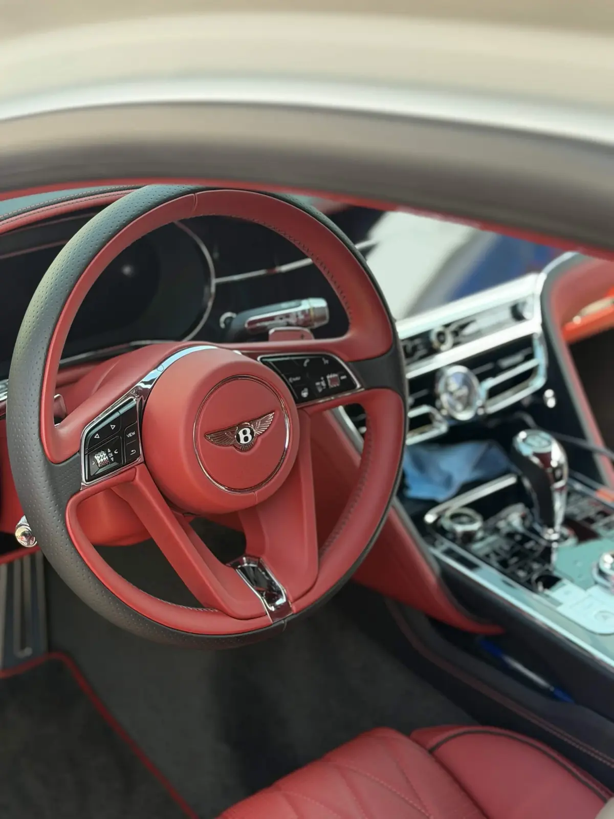 Red leather Bentley interior, steering wheel and console