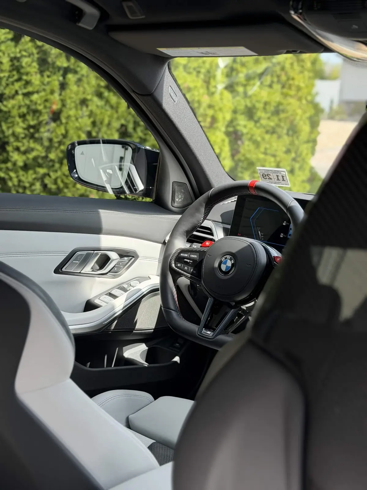 BMW M3 cabin with carbon steering wheel and grey leather