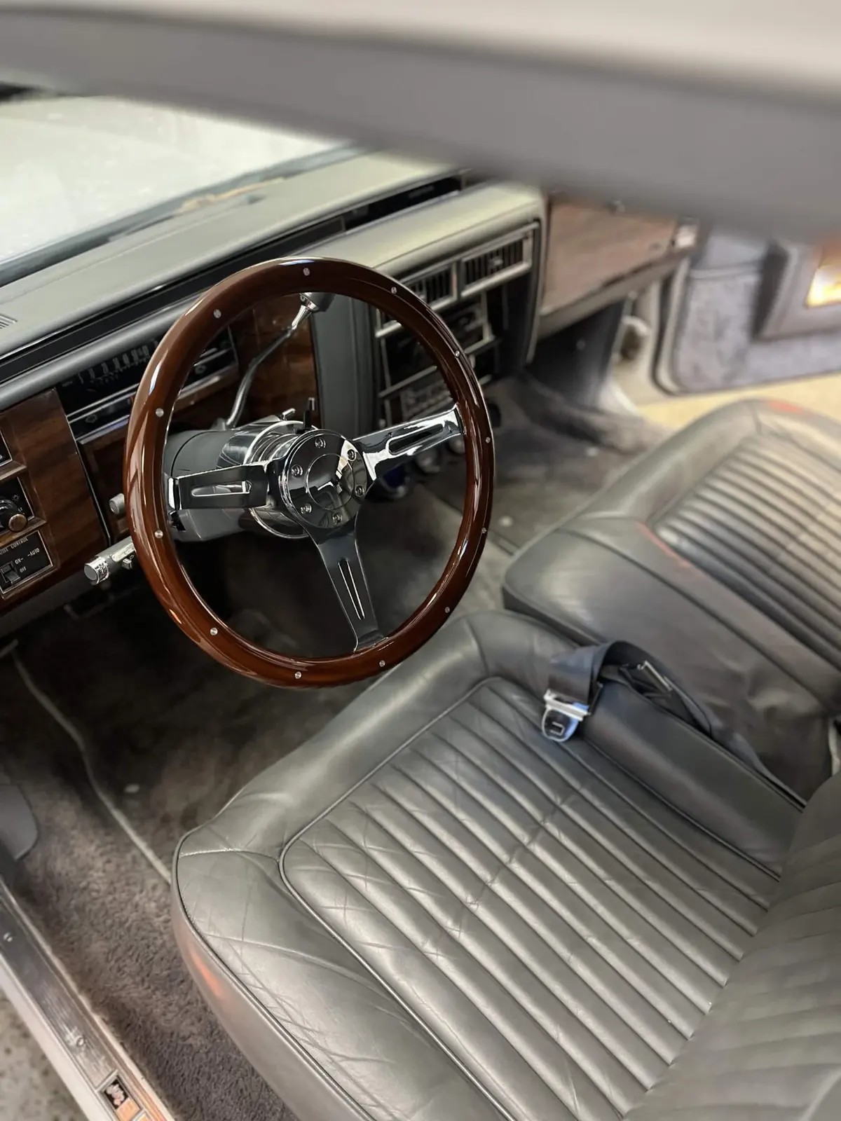 Classic Cadillac interior with wood steering wheel