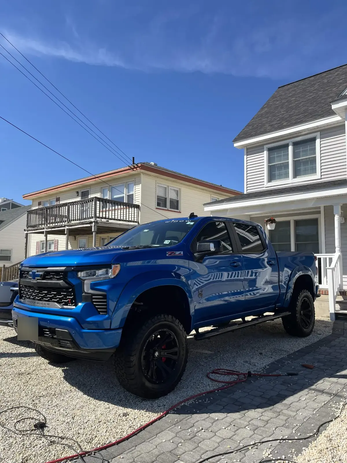 Lifted blue Chevy Silverado Black Widow