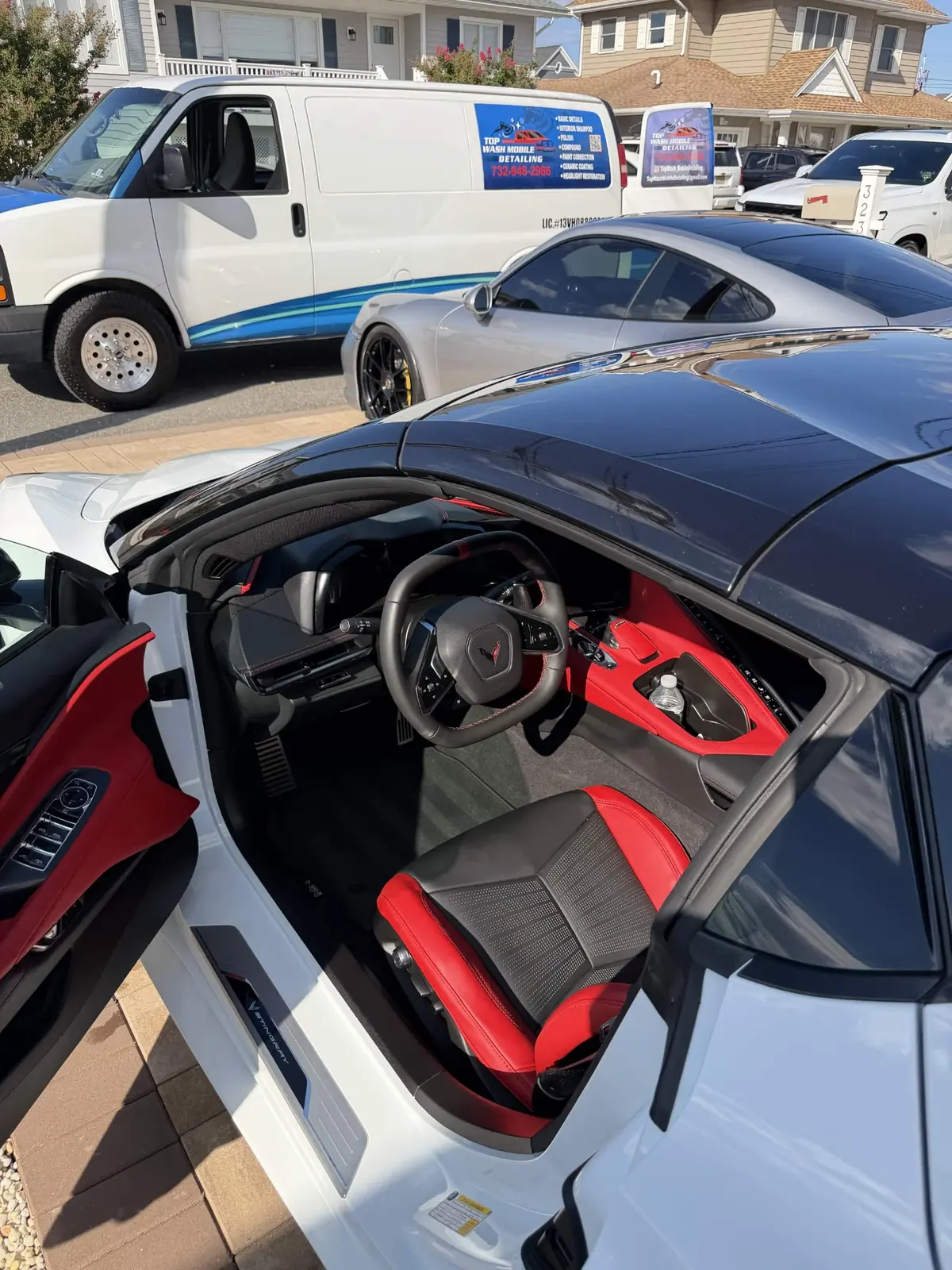 Red and black C8 Corvette interior with the door open