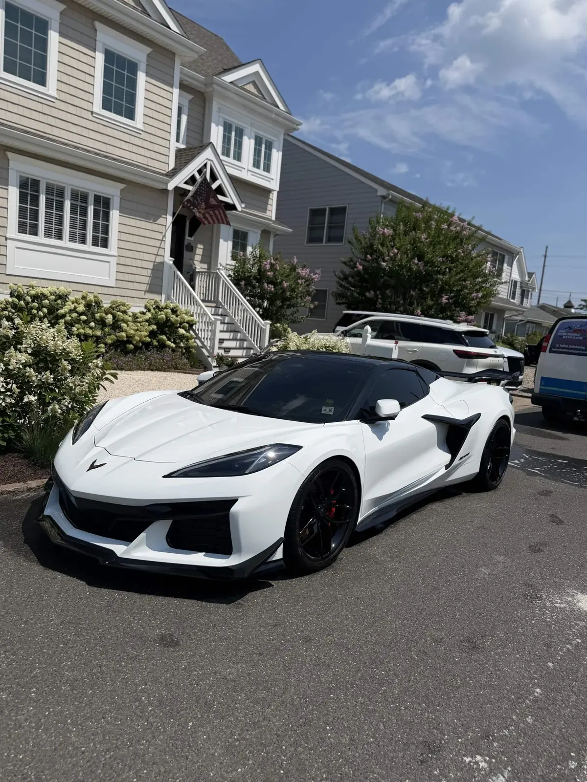 White Corvette Z06 in a shore-house driveway