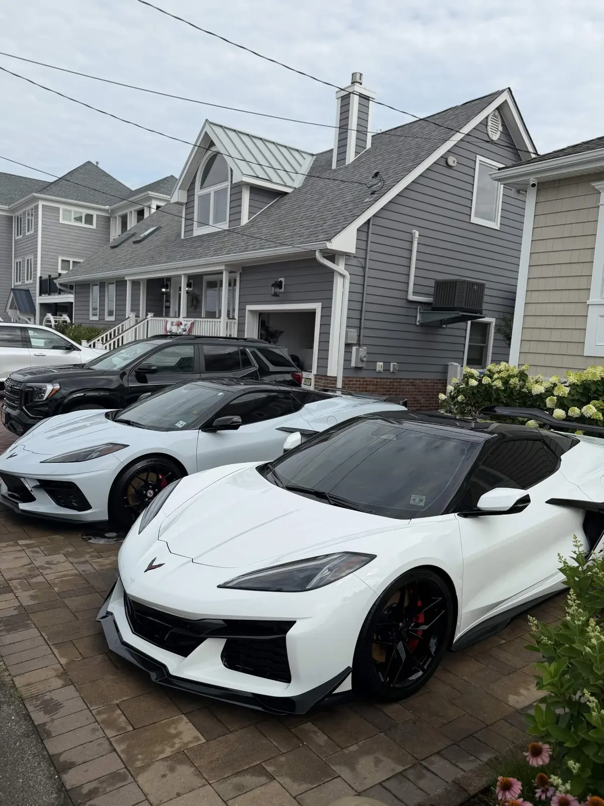 Two white Corvettes detailed by Top Wash in an Ocean County driveway