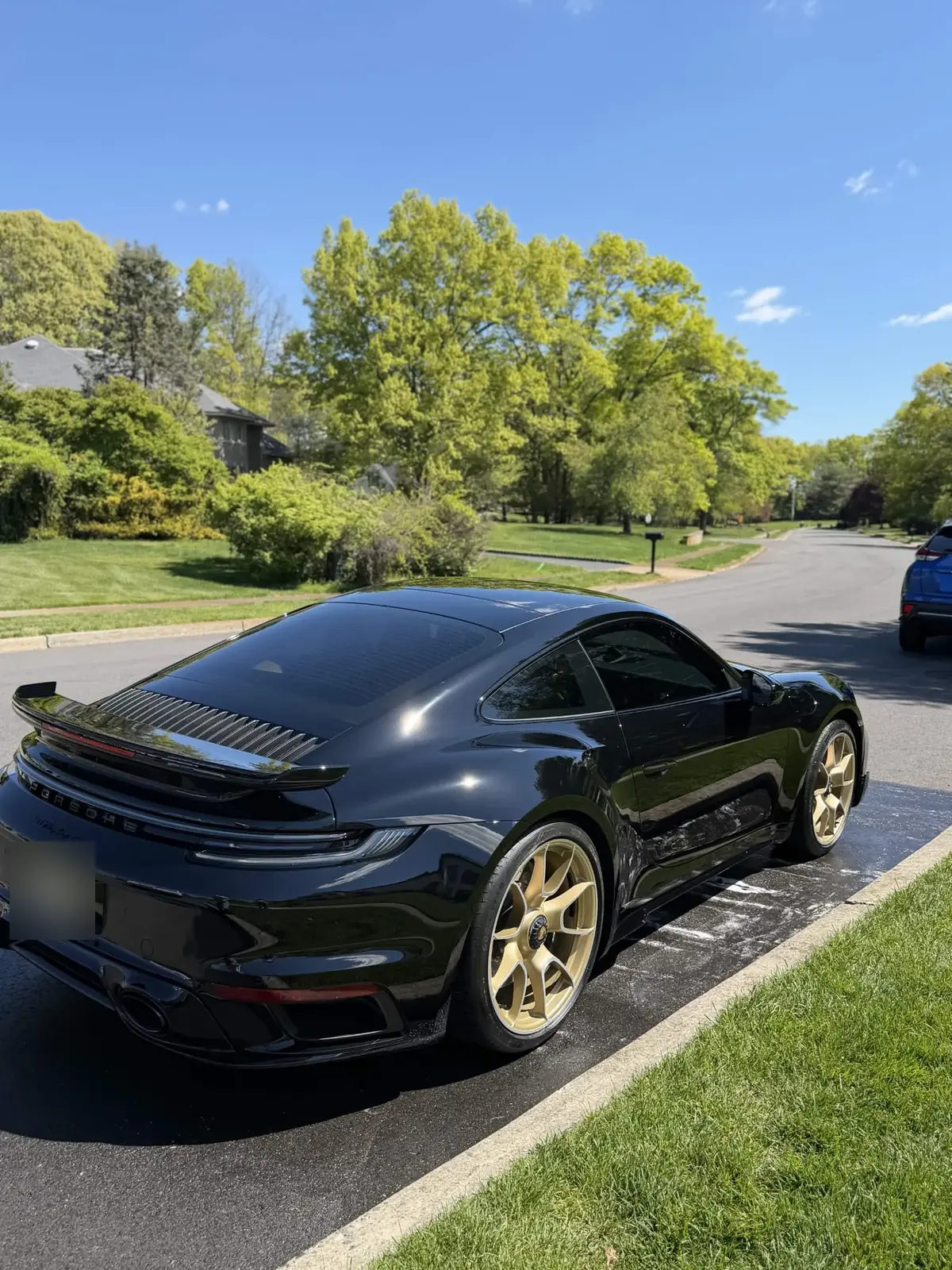 Black Porsche 911 Turbo S on gold wheels