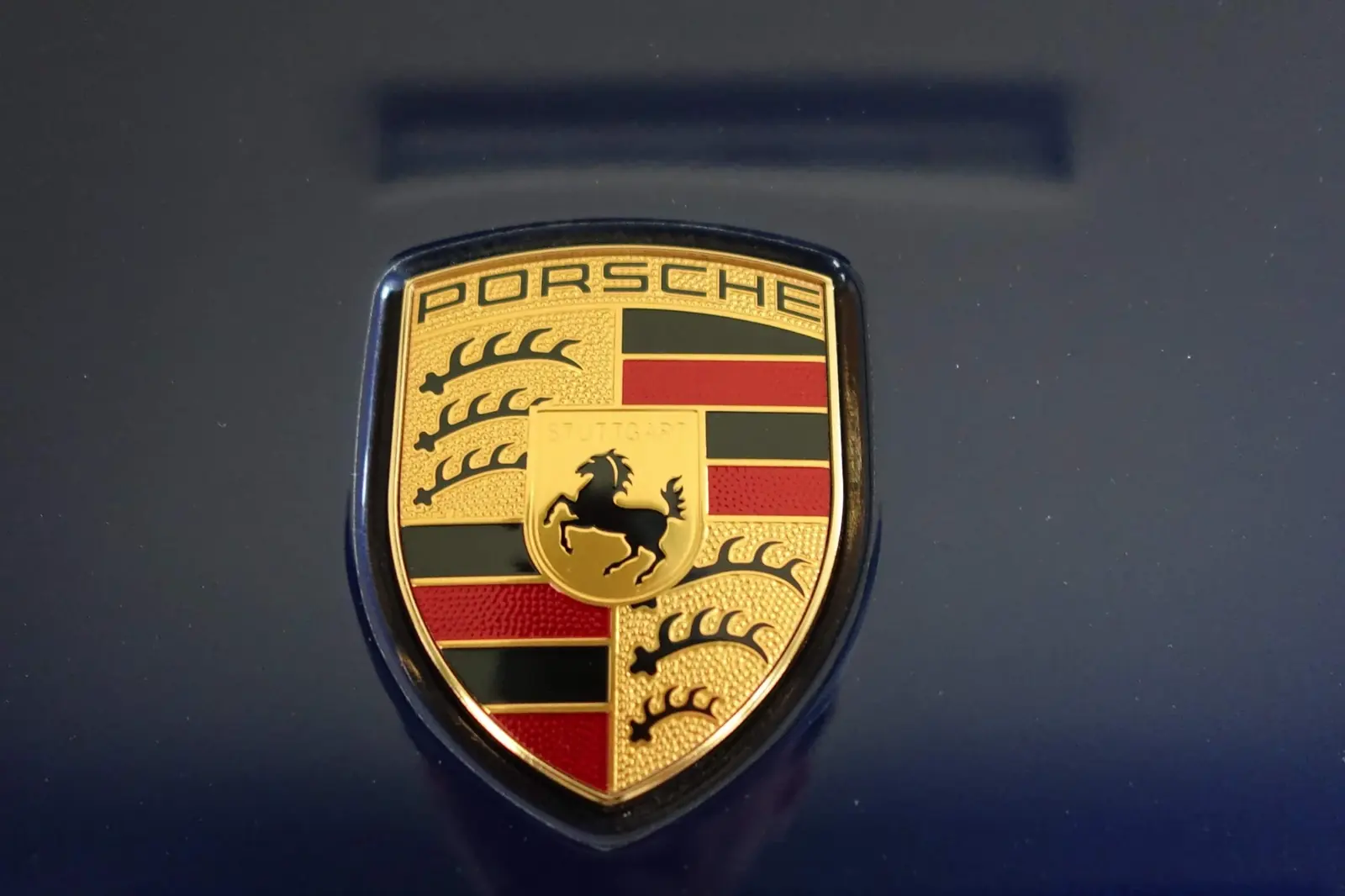 Porsche crest on Gentian Blue paint