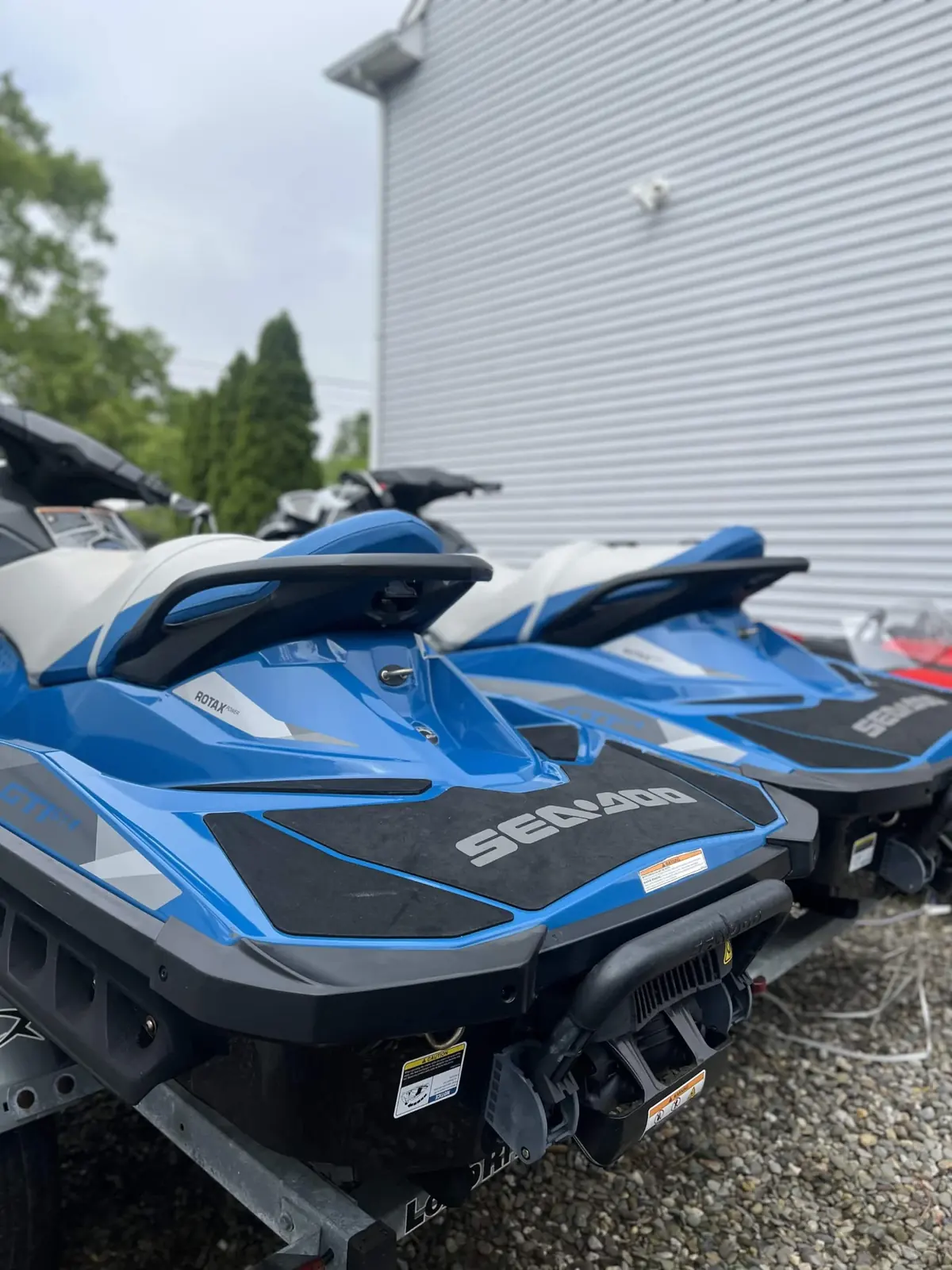 Two Sea-Doo GTI jet skis on trailers