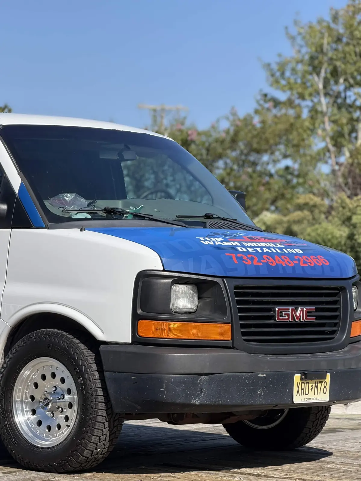 Front of the Top Wash van with phone number on the hood